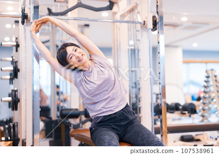 Middle-aged woman training at the gym Middle-aged woman training at the gym 107538961