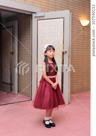 Elementary school girl in a dress Elementary school girl in a dress 107540152