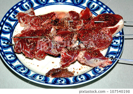 I skewered deer meat at camp. 107540198