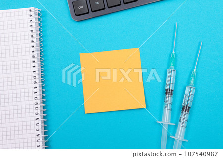 Vaccination or Revaccination Concept - Two Medical Syringe on Blue Table 107540987