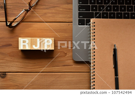 RJP 中排列的木製立方體、電腦、筆記本和筆 RJP 中排列的木製立方體、電腦、筆記本和筆 107542494
