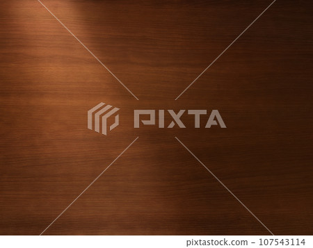Background image of a delicate brown wood desk top with light shining diagonally from the upper left Background image of a delicate brown wood desk top with light shining diagonally from the upper left 107543114