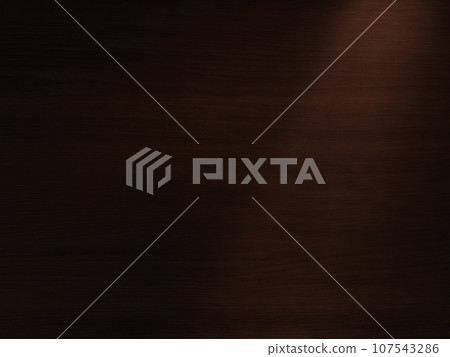 Background image of a desk top with a delicate dark brown wood grain, with light shining diagonally from the top right. Background image of a desk top with a delicate dark brown wood grain, with light shining diagonally from the top right. 107543286