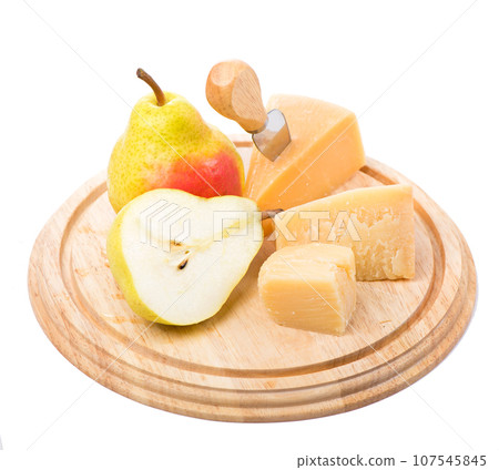 parmesan cheese and ripe pears on a wooden board on a white background 107545845