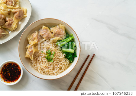 egg noodles with pork wonton soup or pork dumplings soup and vegetable 107546233
