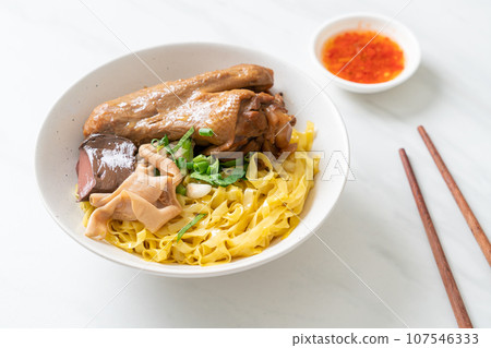 Egg noodles served dry with braised duck Egg noodles served dry with braised duck 107546333