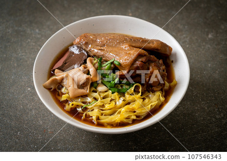 egg noodles with stewed and braised duck in brown soup 107546343