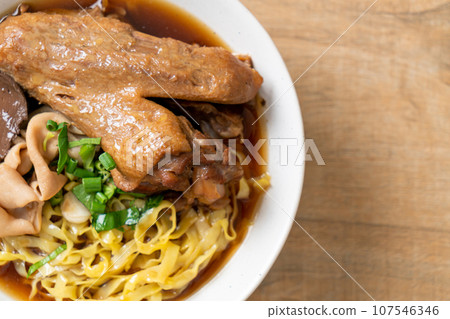 egg noodles with stewed and braised duck in brown soup egg noodles with stewed and braised duck in brown soup 107546346