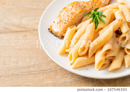 salmon with penne pasta cream sauce 107546393