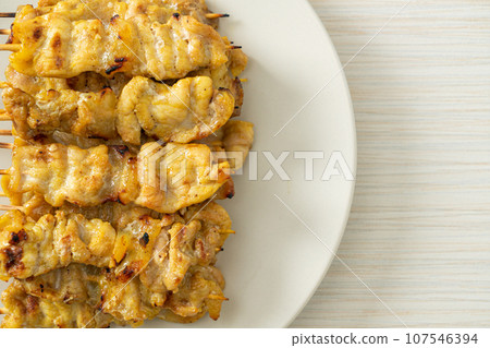 Pork satay with peanut sauce pickles which are cucumber slices and onions in vinegar Pork satay with peanut sauce pickles which are cucumber slices and onions in vinegar 107546394