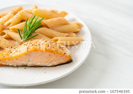 salmon with penne pasta cream sauce 107546395