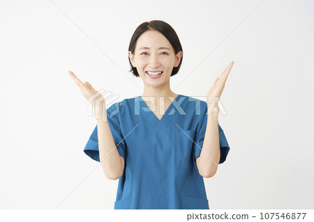 Female doctor pointing to both sides with palms, white background 107546877