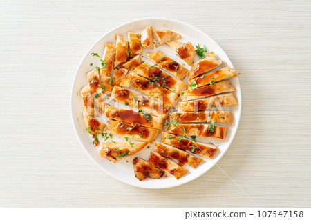 grilled chicken breast sliced on plate 107547158