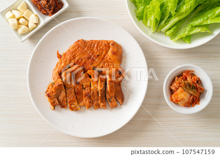 grilled pork marinated Kochujang sauce in Korean style with vegetable and kimchi 107547159