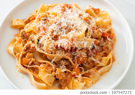 Homemade pasta fettuccine bolognese with cheese 107547271