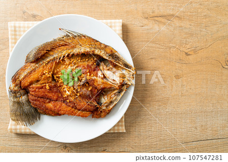 Fried Sea Bass Fish with Garlic Fried Sea Bass Fish with Garlic 107547281