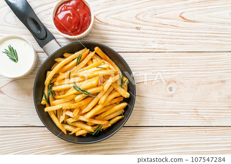 French fries with sour cream and ketchup 107547284