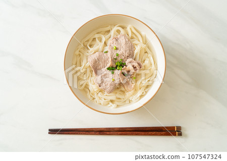 udon noodles with pork in clear soup 107547324