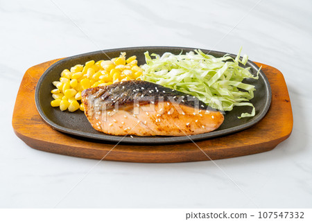 grilled salmon fillet steak on hot plate grilled salmon fillet steak on hot plate 107547332
