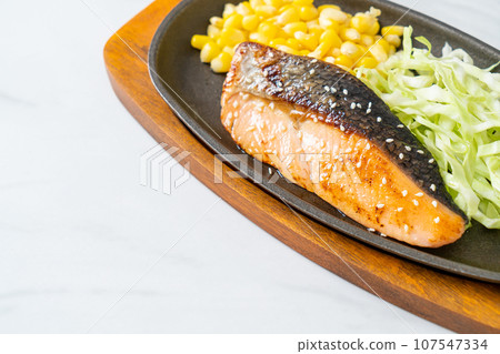 grilled salmon fillet steak on hot plate grilled salmon fillet steak on hot plate 107547334