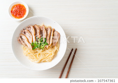 dried noodles with stewed duck in white bowl 107547361