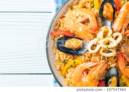 Seafood Paella with prawns, clams, mussels on saffron rice 107547464