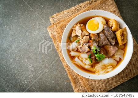 paste of rice flour or boiled Chinese pasta square in clear soup 107547492