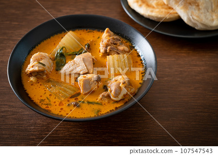 Chicken curry soup with roti Chicken curry soup with roti 107547543