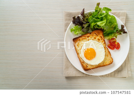bread toasted with cheese and fried egg 107547581