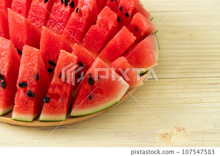 fresh watermelon sliced on plate 107547583