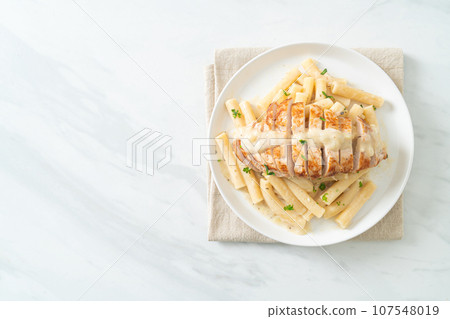 quadrotto penne pasta white creamy sauce with grilled chicken 107548019