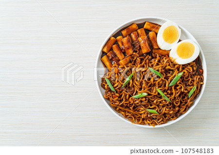 Jjajang Rabokki - Korean instant noodles or Ramyeon with Korean rice cake or Tteokbokki and egg in black bean sauce 107548183