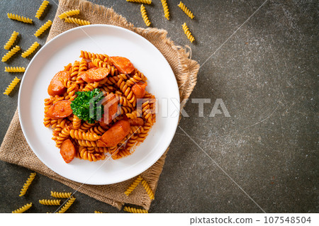 spirali or spiral pasta with tomato sauce 107548504