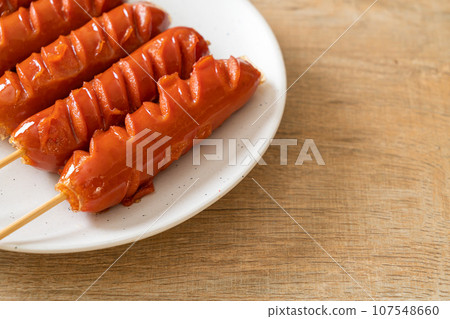 fried sausage skewer on plate 107548660