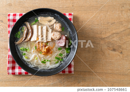 Vietnamese Rice Noodles Soup with Vietnamese Sausage served vegetables and crispy onion 107548661