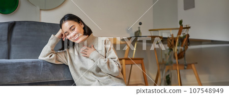Vertical shot of beautiful asian woman, student sitting at home and studying remotely, elearning with laptop Vertical shot of beautiful asian woman, student sitting at home and studying remotely, elearning with laptop 107548949