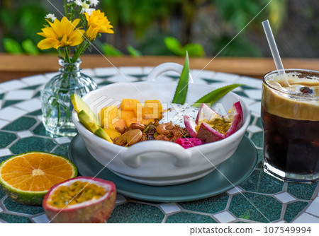 Granola with greek yogurt, honey, fresh fruits, chia seeds served with ice americano Granola with greek yogurt, honey, fresh fruits, chia seeds served with ice americano 107549994