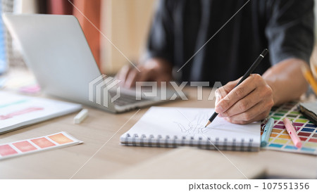 Fashion designer man work to designing clothes and sketching in paper for creative new collection 107551356