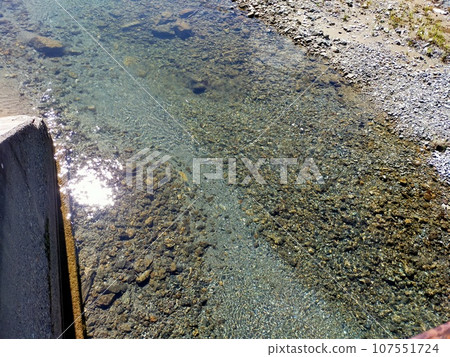 Clear water river seen from the top of the bridge, clear stream, riverbed Clear water river seen from the top of the bridge, clear stream, riverbed 107551724