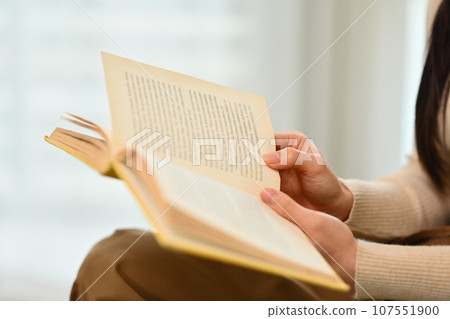 Young woman reading book, enjoying leisure weekend time at home. Education, leisure and lifestyle concept Young woman reading book, enjoying leisure weekend time at home. Education, leisure and lifestyle concept 107551900
