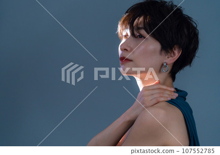 A middle-aged woman doing skin care against a black background A middle-aged woman doing skin care against a black background 107552785
