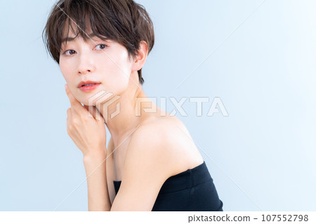 A middle-aged woman doing skin care against a gray background A middle-aged woman doing skin care against a gray background 107552798