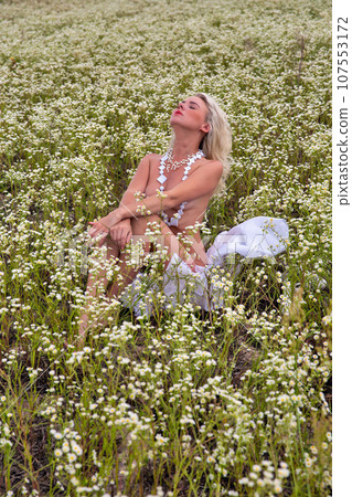 Young beautiful sexy naked woman in the summer morning field. 107553172