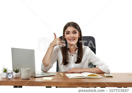 woman using laptop and doing talking on the telephone gesture. woman using laptop and doing talking on the telephone gesture. 107553687