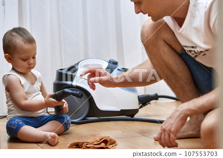 baby girl helps her dad cleaning with professional cleaning steam generator, baby girl helps her dad cleaning with professional cleaning steam generator, 107553703