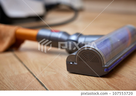 close-up, cordless vacuum cleaner on the floor. close-up, cordless vacuum cleaner on the floor. 107553720