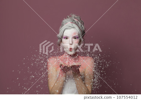 Snow Queen woman with snowflake. Creative fantasy makeup. Carnival or Halloween party concept 107554012