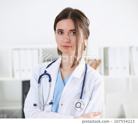 Beautiful smiling female doctor stand in office 107554223