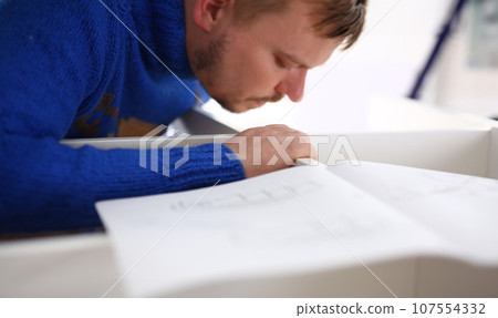 Male arms assembling furniture closeup Male arms assembling furniture closeup 107554332