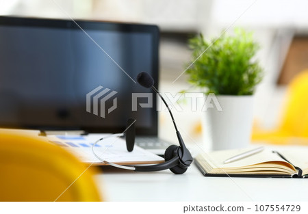 Empty remote office workplace with laptop and headset 107554729